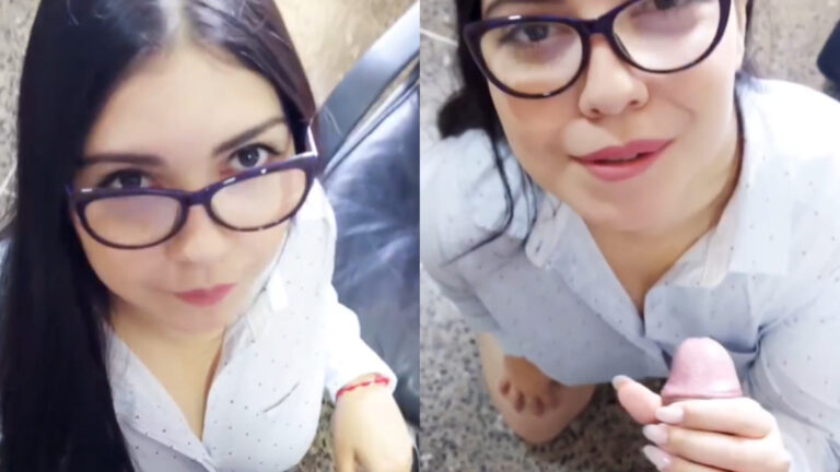 Cereza con gafas y camisa blanca chupa una polla con cara traviesa